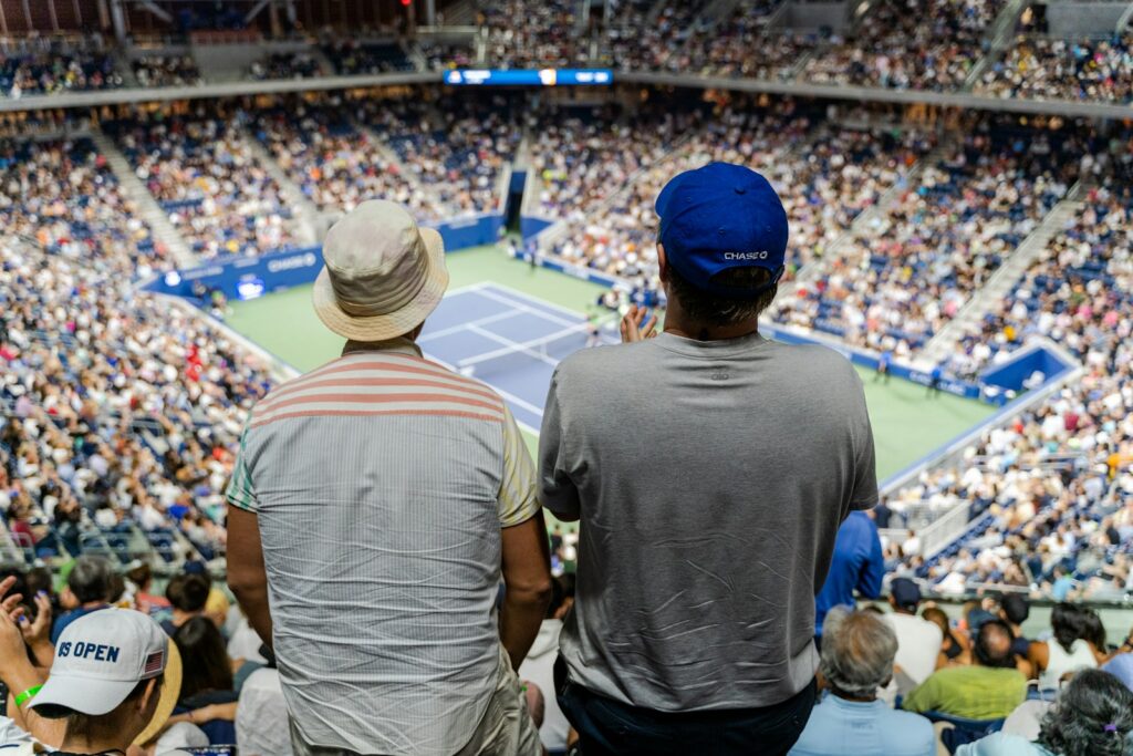 Spectators watching a tennis match from the stands