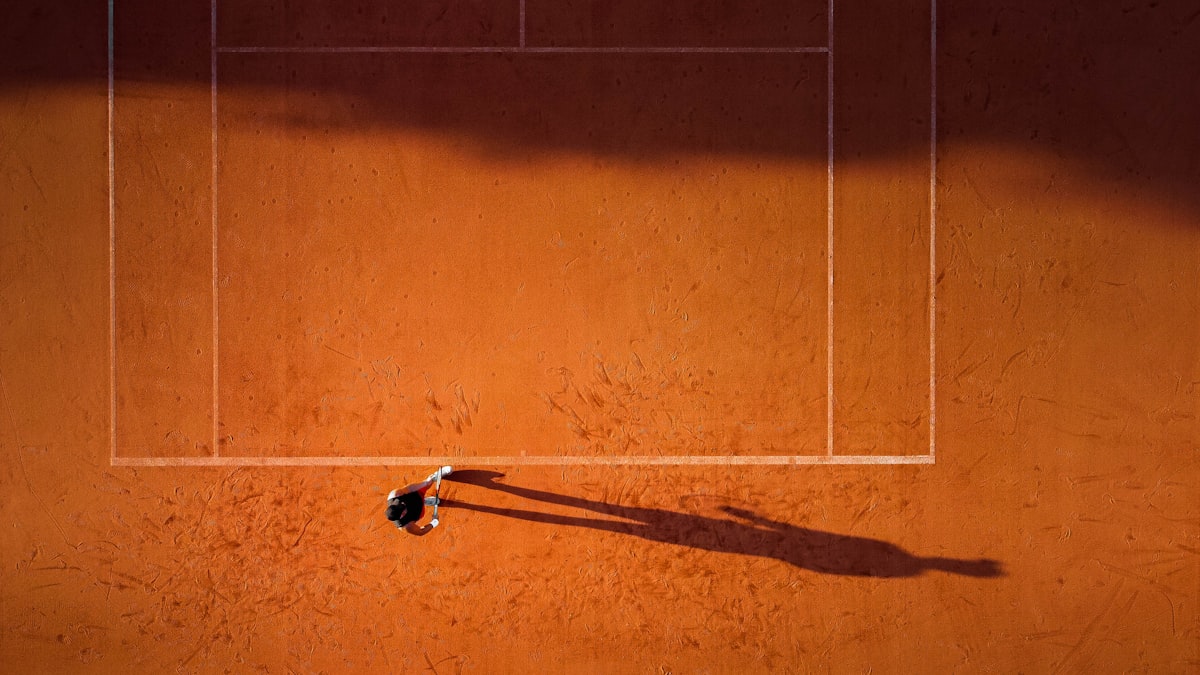 Player in a tennis outfit moving on court